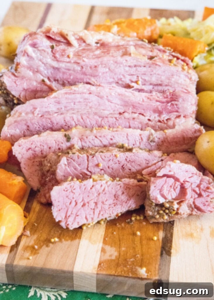 Perfect Instant Pot Corned Beef 5 Perfectly sliced corned beef brisket on a cutting board, ready to be served