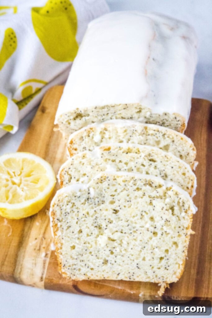 Overhead shot of sliced lemon poppy seed bread with glaze drizzled over.