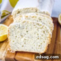 Close-up of a delicious slice of Lemon Poppy Seed Bread with a delicate glaze.