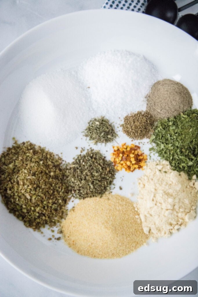 Classic Italian Salad Mix 2 A selection of individual dried spices arranged neatly on a white plate, ready to be blended into Italian dressing mix.