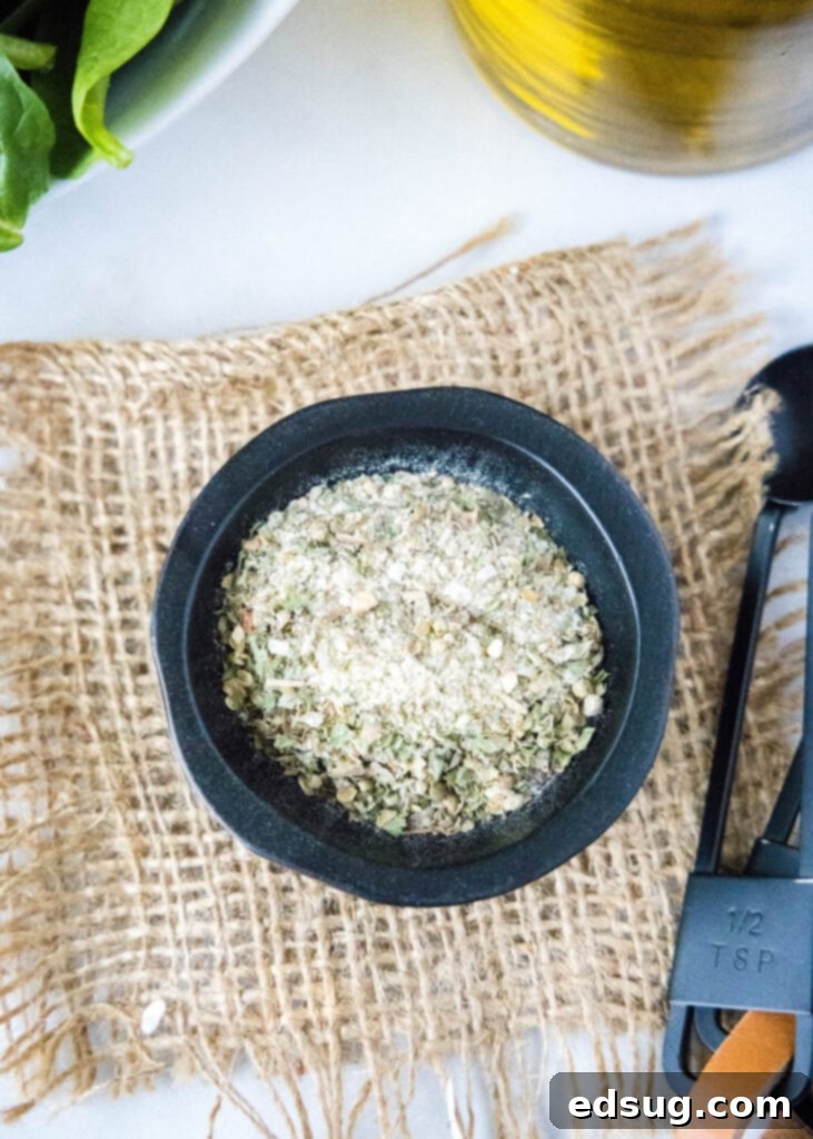 Classic Italian Salad Mix 5 A small, elegant white bowl filled with the homemade Italian dressing mix, ready for use.