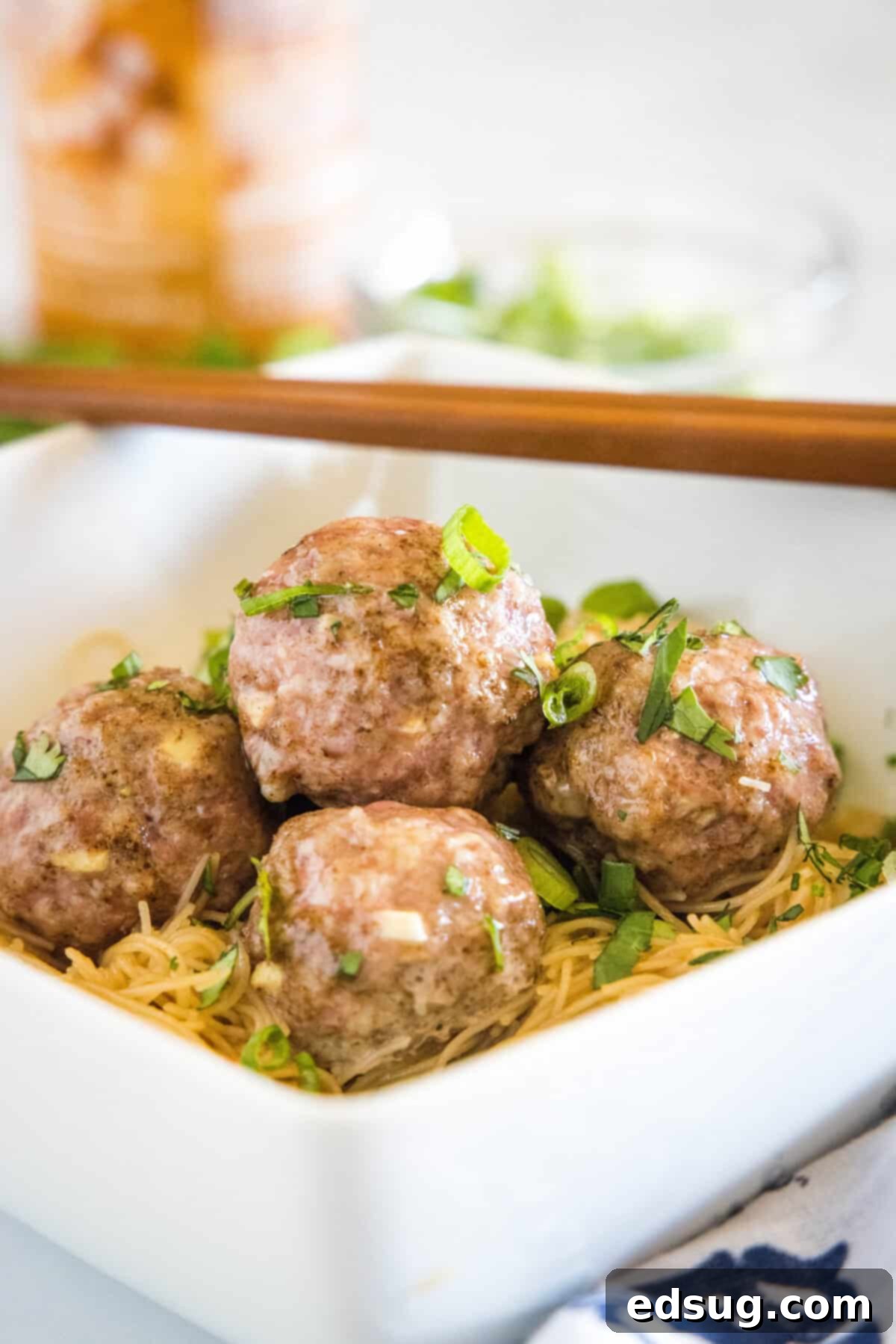 asian meatballs over rice noodles in a bowl