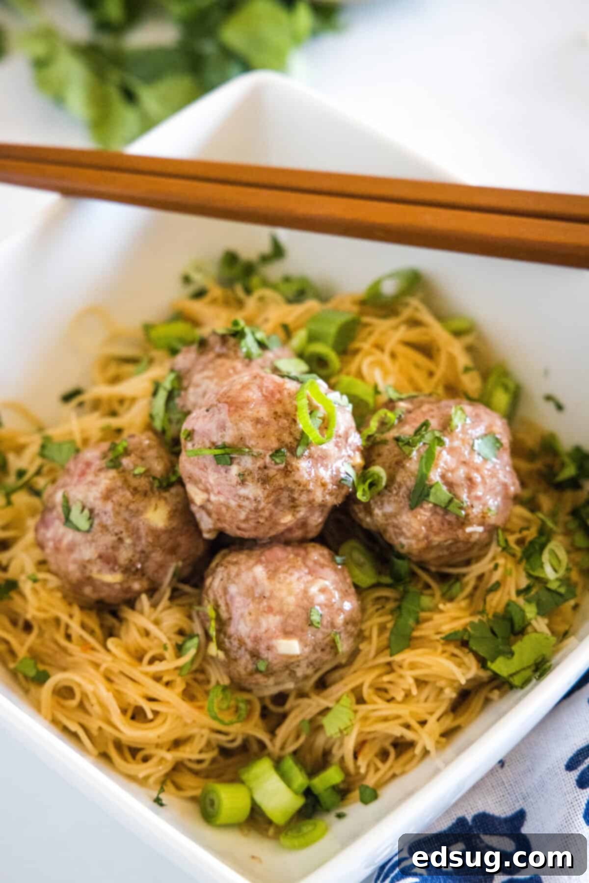 looking down on a asian meatballs over rice noodles
