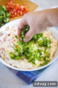 blt dip spread in a bowl topping with lettuce