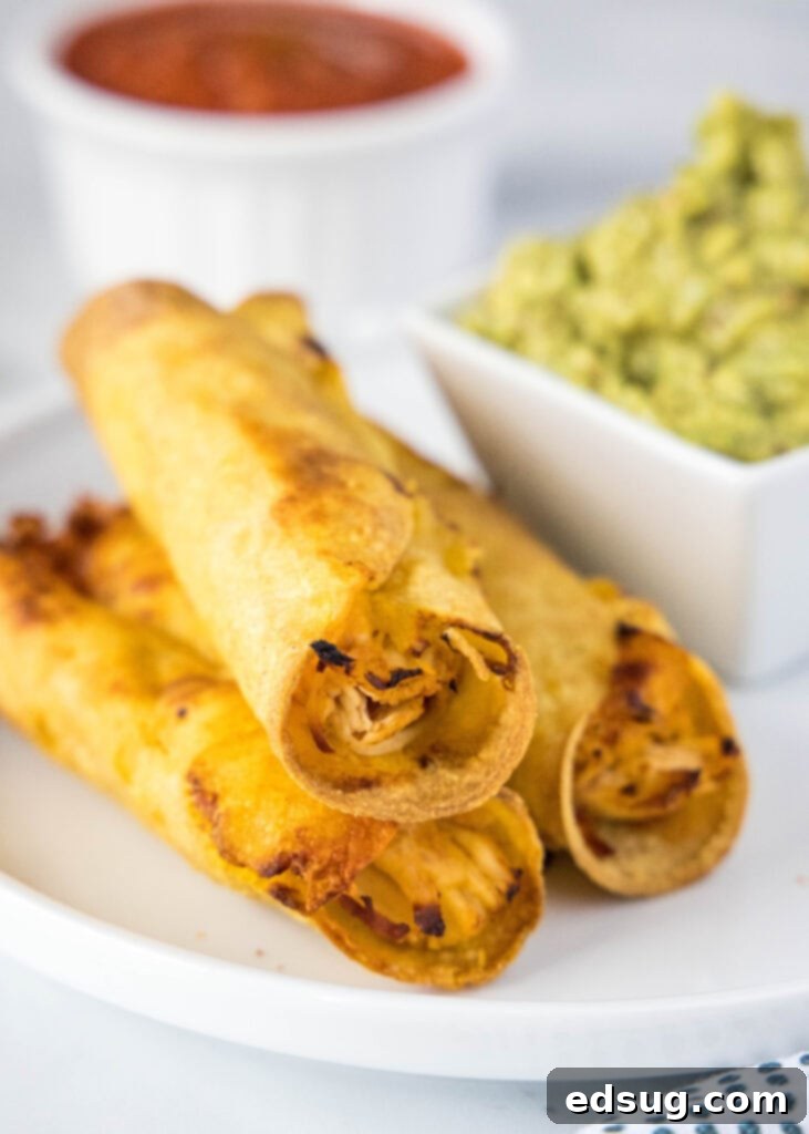 3 chicken taquitos stacked on a plate