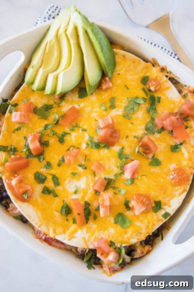 Burrito Bake 7 Looking down into a baking pan filled with a freshly baked Burrito Casserole, garnished.