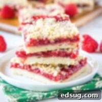 Luscious Raspberry Crumble Bars 7 close up stack of raspberry bars on a white plate