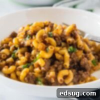Classic Beefaroni 2 A white bowl with beefaroni and a fork, highlighting the inviting homemade dish.
