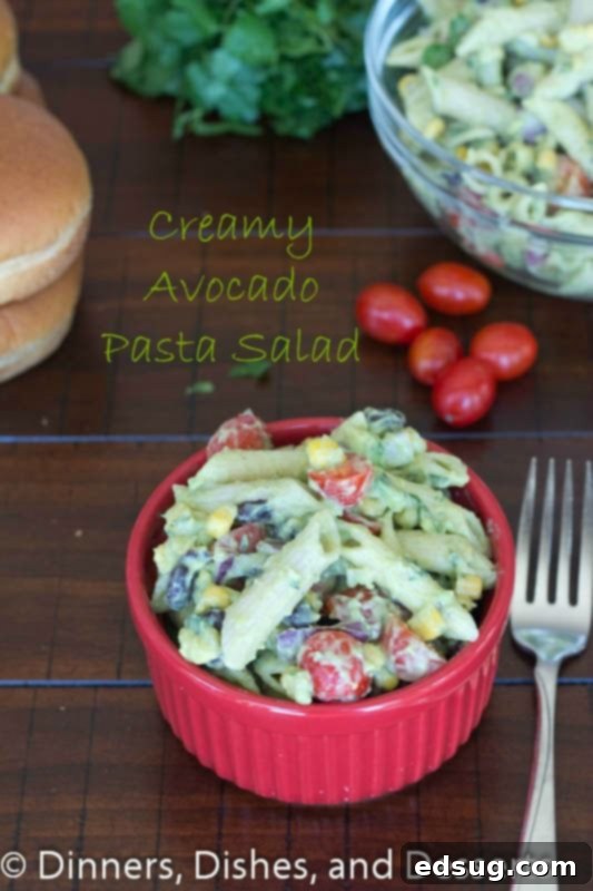 Creamy Avocado Pasta Salad | Dinners, Dishes, and Desserts Creamy Avocado Pasta Salad in a large serving bowl, garnished with fresh cilantro, ready to be served at a summer gathering