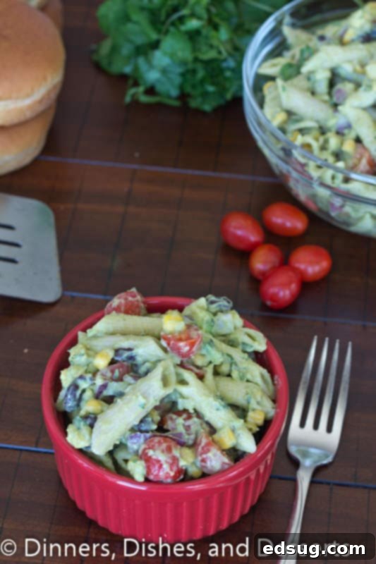 Creamy Avocado Pasta Salad | Dinners, Dishes, and Desserts A large bowl of Creamy Avocado Pasta Salad from a slightly elevated angle, showcasing the vibrant colors and fresh ingredients