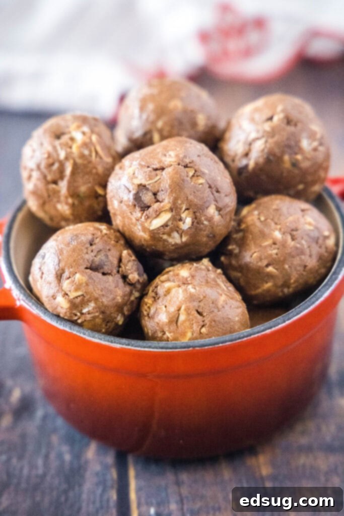 Power Chocolate Protein Bites 2 A vibrant red bowl filled with delicious no-bake chocolate energy bites, ready for a quick and healthy snack.