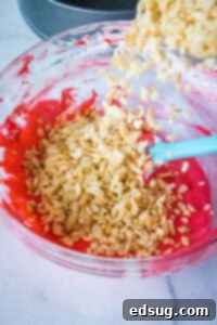 Watermelon Splash Krispies 5 adding krispies to melted red marshmallows