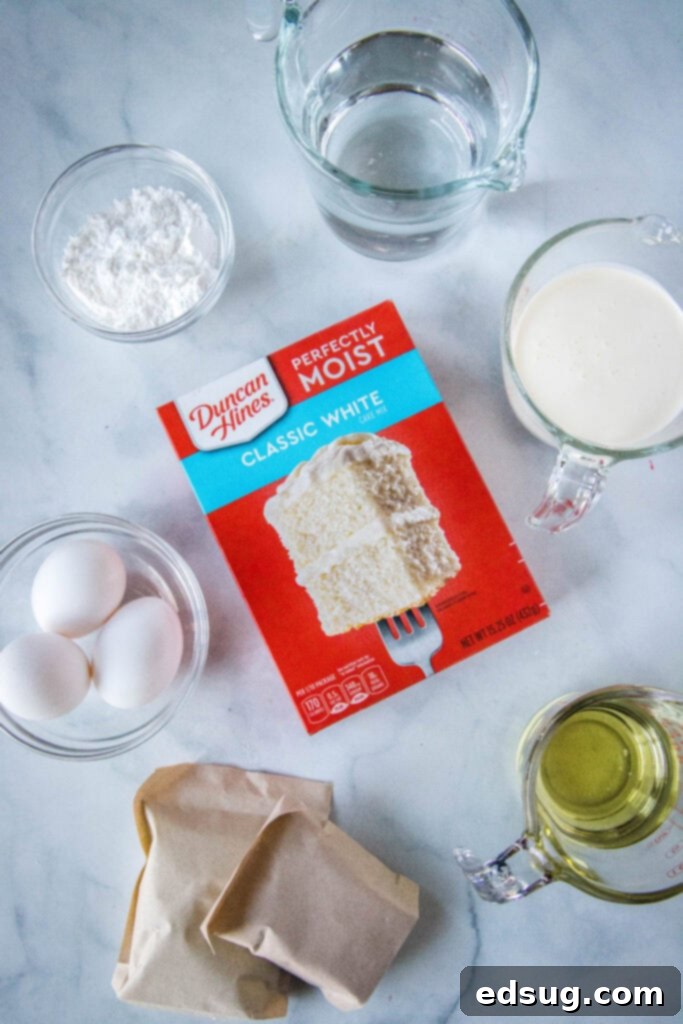 Ingredients for 4th of July poke cake including cake mix, jello, heavy cream, and sprinkles