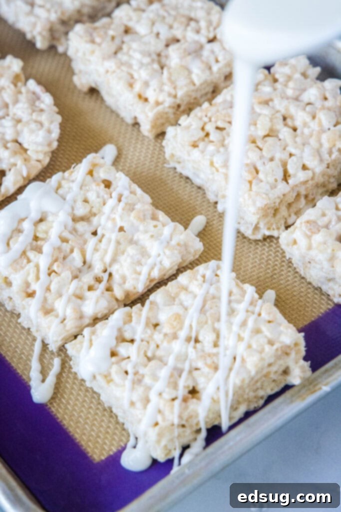 drizzling white chocolate on rice krispie treats