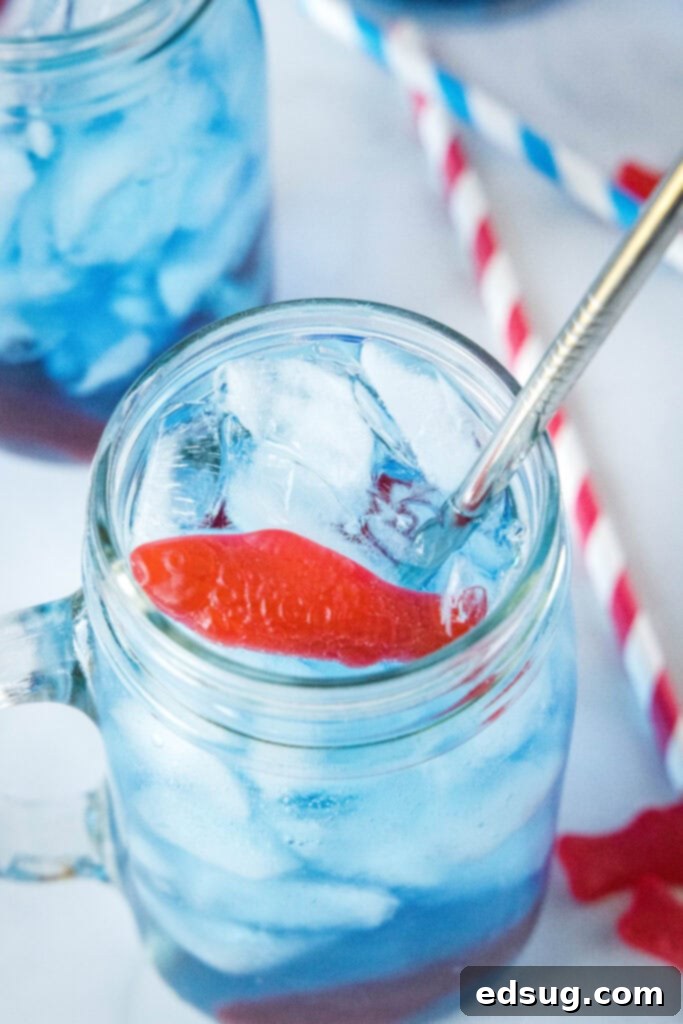AquaPulse Dynamics 4 Overhead view of a glass of Sonic Ocean Water with a straw and Swedish fish garnish.