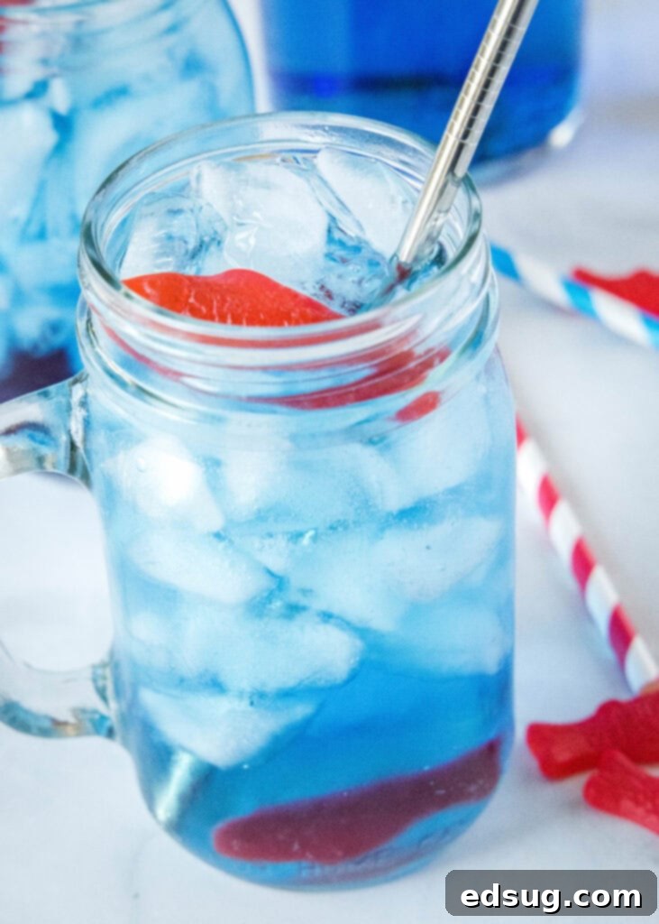 AquaPulse Dynamics 5 Close-up of a refreshing glass of Sonic Ocean Water with ice and a straw.