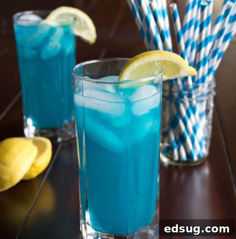 Refreshing Blue Vodka Lemonade with Lemon Garnish Stylish close-up of blue vodka lemonade in a glass, with a slice of lemon on the rim