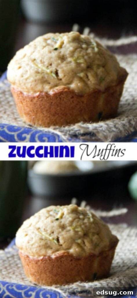 Close-up of a single golden-brown zucchini muffin, showcasing its texture and delicious interior, resting on a rustic wooden surface.