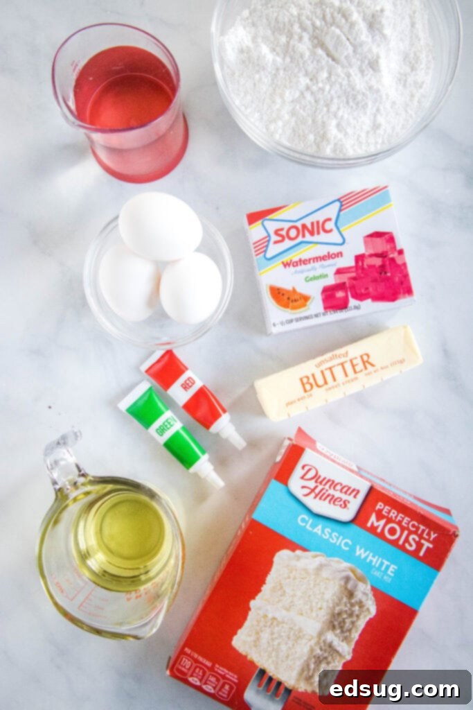 Watermelon Wonder Cupcakes 3 Ingredients laid out for making watermelon cupcakes, including cake mix, butter, powdered sugar, Kool-Aid, and food coloring