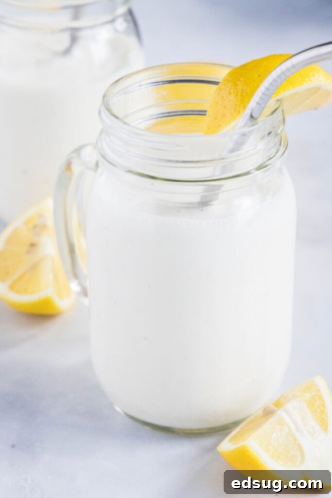 Chick-fil-A's Creamy Lemon Bliss 2 A glass of homemade frosted lemonade garnished with fresh lemon slices, looking refreshing and delicious.