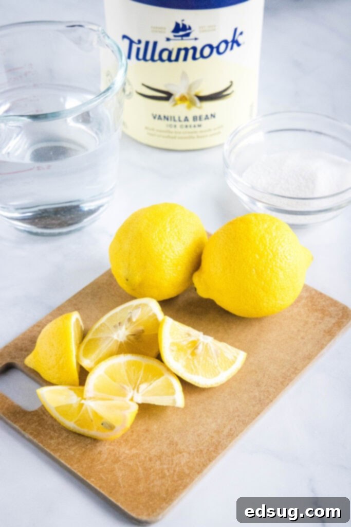 Chick-fil-A's Creamy Lemon Bliss 3 Essential ingredients for homemade frosted lemonade laid out: fresh lemons, granulated sugar, and a tub of vanilla ice cream.