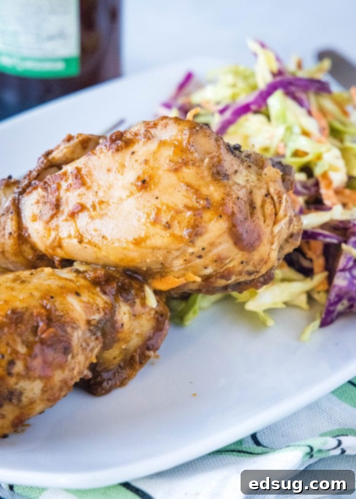 Fall-Off-The-Bone Slow Cooker Drumsticks 2 Close up of slow cooker chicken drumsticks with barbecue sauce, garnished with fresh parsley.