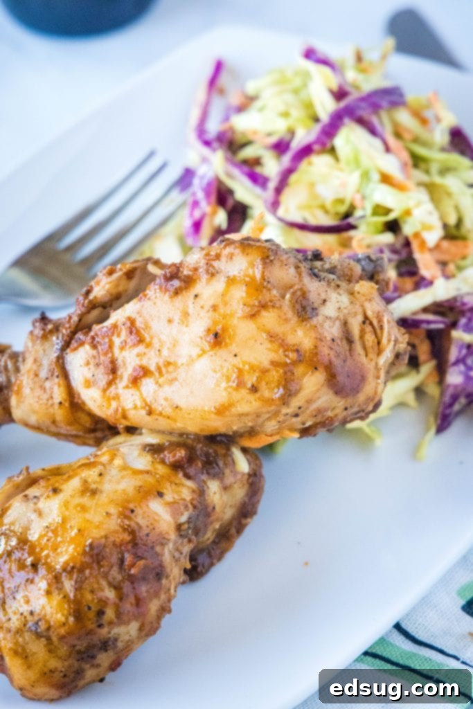 Fall-Off-The-Bone Slow Cooker Drumsticks 6 Plated barbecue chicken drumsticks served with a side of creamy coleslaw.