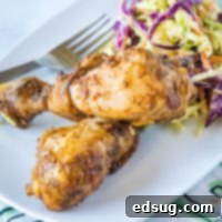 Fall-Off-The-Bone Slow Cooker Drumsticks 8 Close up of a slow cooker chicken drumstick with barbecue sauce.