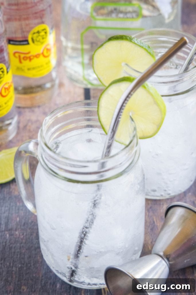 texas ranch water in a glass with a straw and lime garnish on a table