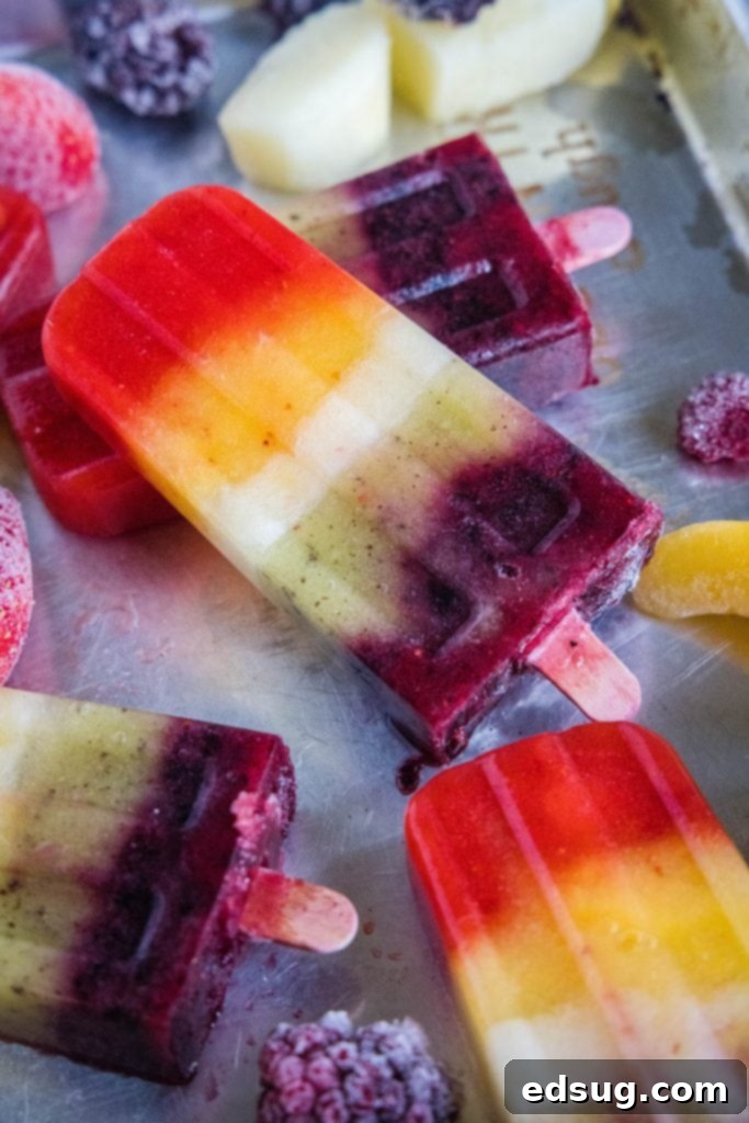 close up rainbow popsicles on a baking tray