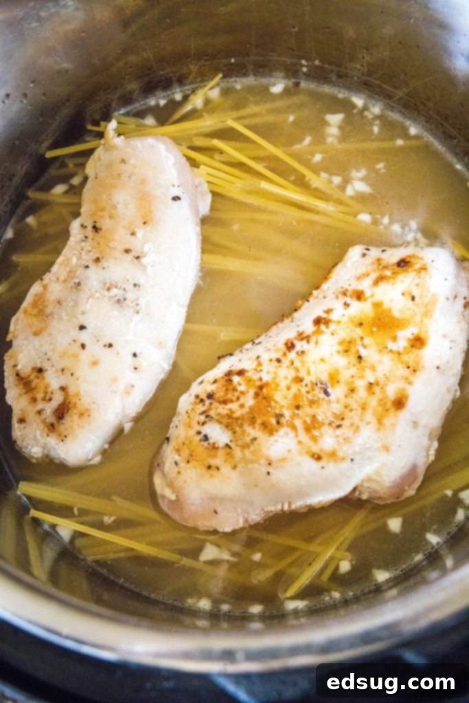 One Pot Wonder Chicken Alfredo 4 all ingredients for Instant Pot chicken alfredo laid out with a pressure cooker