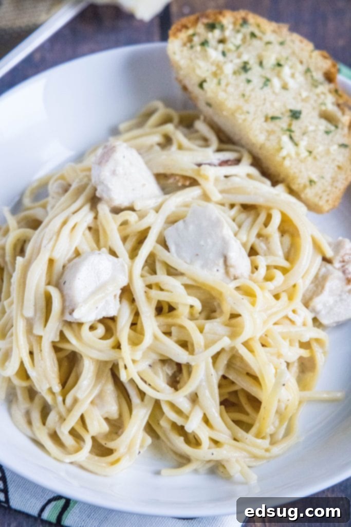 One Pot Wonder Chicken Alfredo 7 instant pot chicken alfredo served in a white bowl with fresh parsley