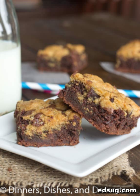 Close-up of a square Brookie bar, showcasing the distinct layers of rich brownie and a golden chocolate chip cookie topping.
