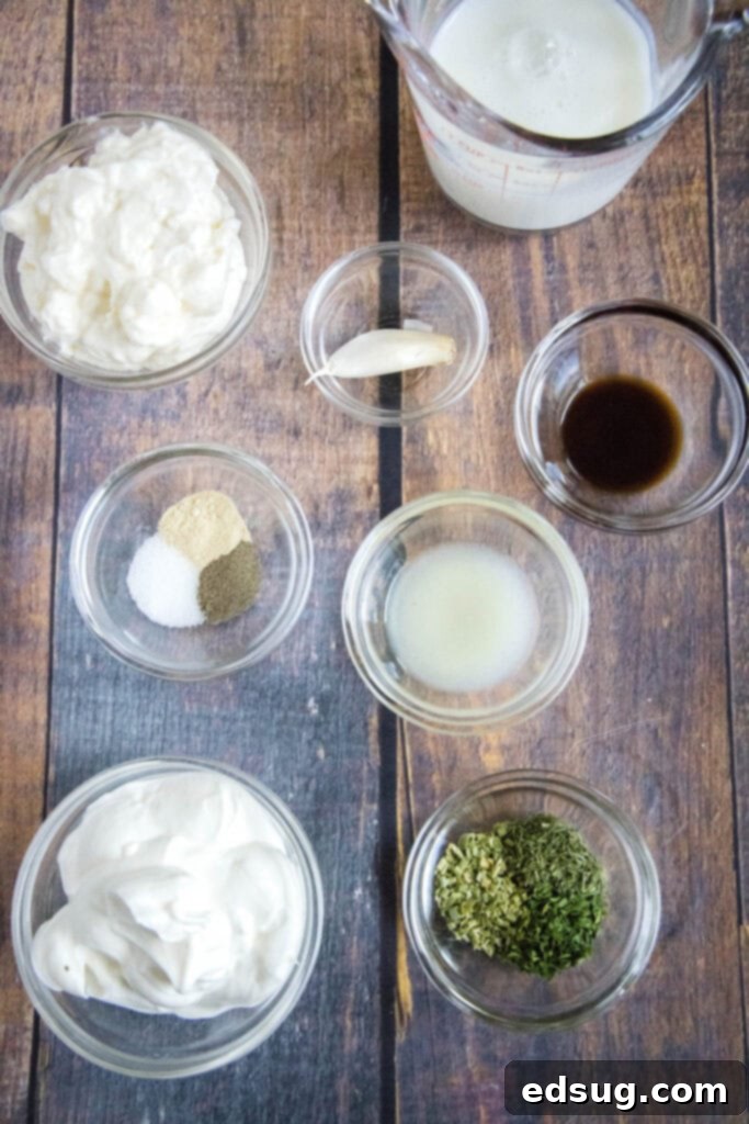 Various fresh ingredients laid out on a counter, ready to be combined for homemade ranch dressing.