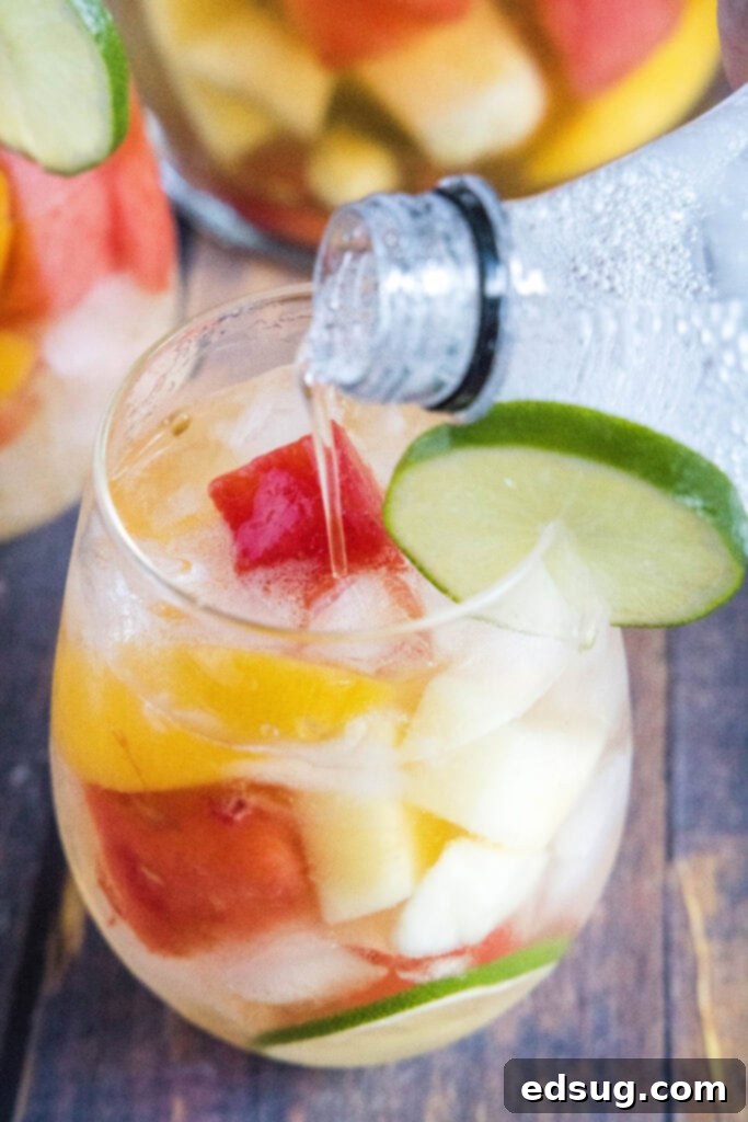Sun-Drenched Sangria 5 pouring sprite into summer sangria