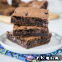 Magic Cake Mix Brownies 2 Three perfectly stacked squares of rich cake mix brownies on a plate, highlighting their moist and fudgy texture