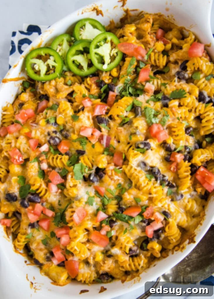 Zesty Southwest Chicken Casserole 5 An overhead view of the baked Fiesta Chicken Casserole in a dish, showcasing the melted cheesy top and the rich filling underneath, ready to be served.