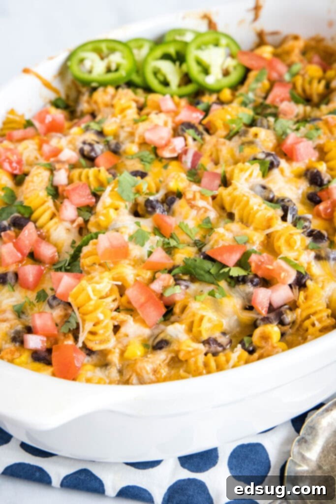 Zesty Southwest Chicken Casserole 7 A close-up of the baked Fiesta Chicken Casserole garnished with fresh diced tomatoes and cilantro, showcasing its appealing presentation.