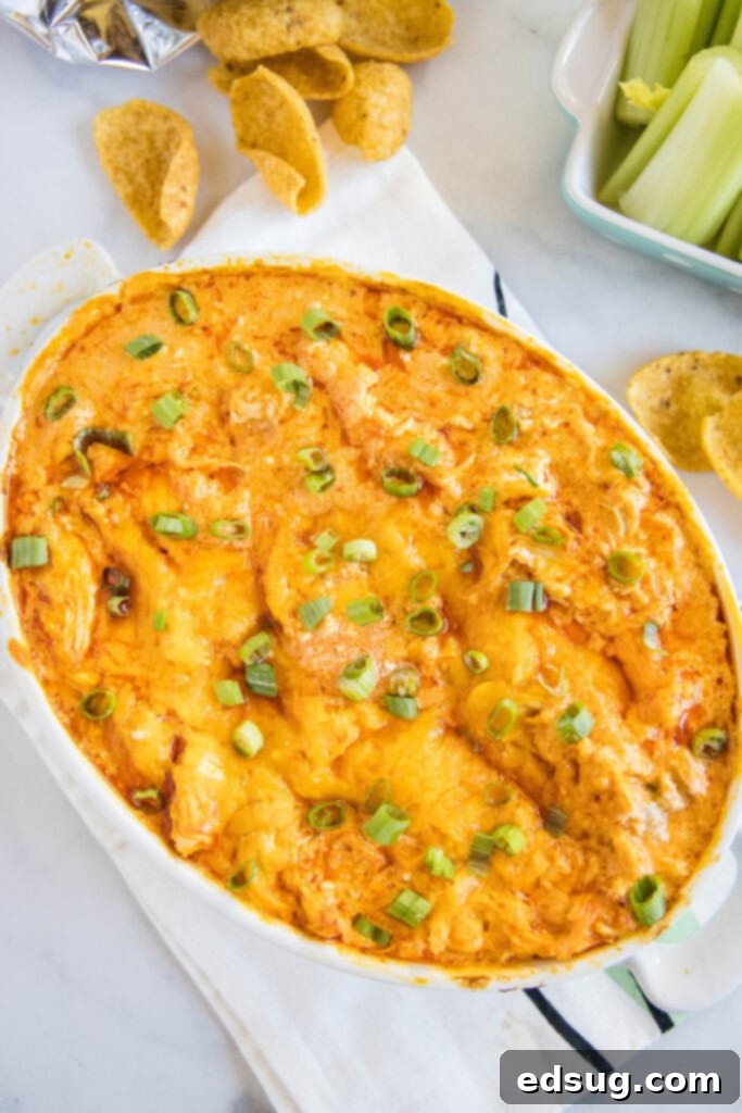 Ultimate Instant Pot Buffalo Chicken Dip 6 overhead shot of a large ceramic dish filled with creamy, hot buffalo chicken dip, garnished and ready to be served