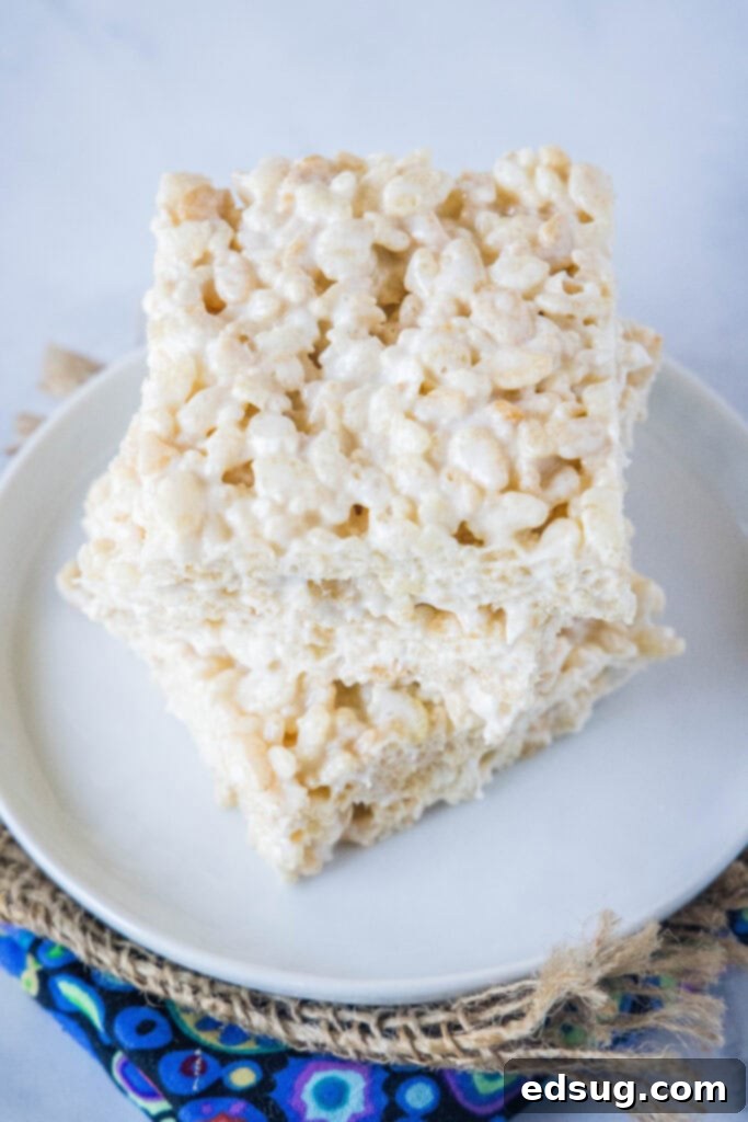 A stack of perfectly cut, golden-brown Rice Krispie Treats, ready to be enjoyed.
