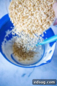 adding rice krispies to melted marshmallows