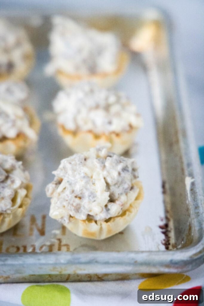 Savory Sausage Cups 4 sausage cups filled and on baking tray