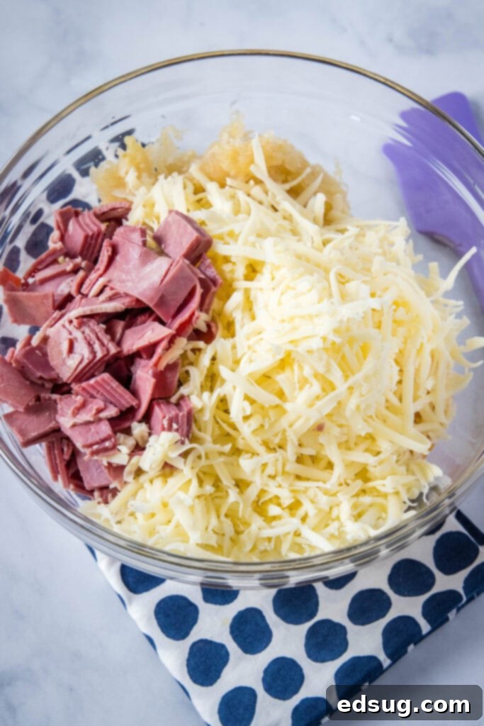 Hot Reuben Dip 4 All the Reuben dip ingredients mixed together in a large glass mixing bowl, ready for baking.