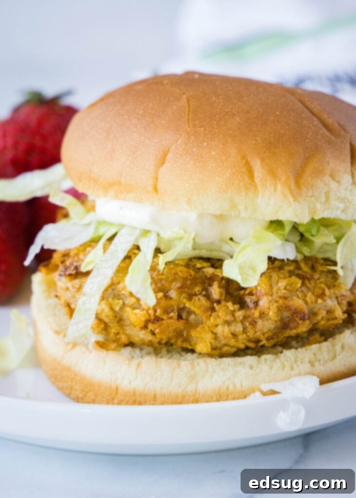 The Ultimate Air Fryer Crispy Chicken Sandwich 2 Crispy chicken sandwich on a white plate with lettuce and mayo