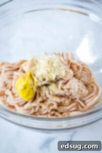 The Ultimate Air Fryer Crispy Chicken Sandwich 8 ground chicken with spices in a mixing bowl