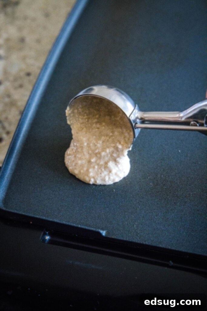 Wholesome Oat Pancakes 4 scooping pancake batter onto a hot griddle, showing the perfect portion size