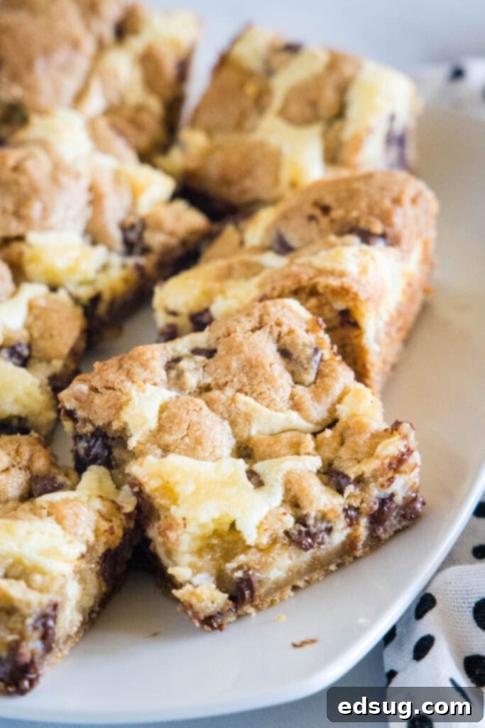 Choc-Chip Cheesecake Dream Bars 5 chocolate chip cookie cheesecake bars on a plate