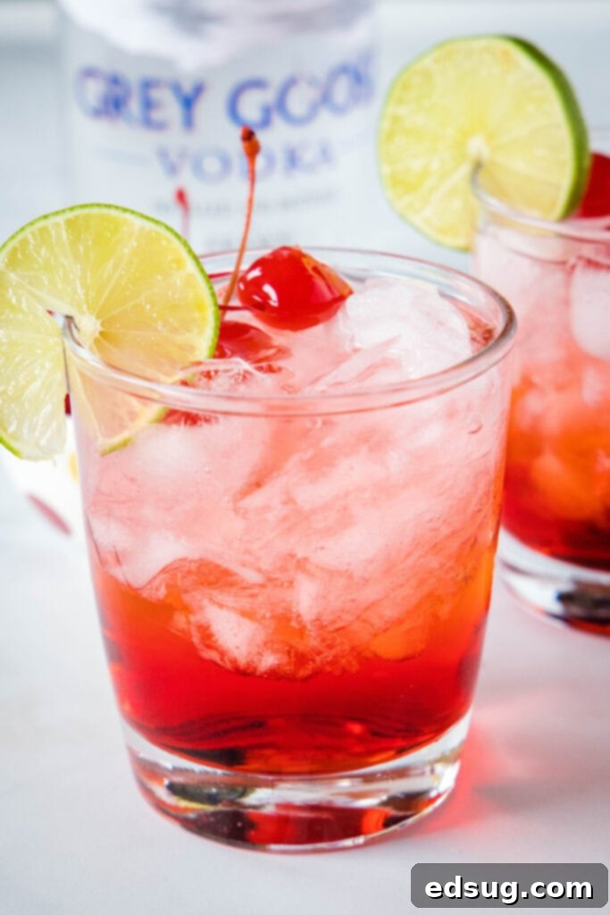 grown up shirley temple in a glass with cherry and lime