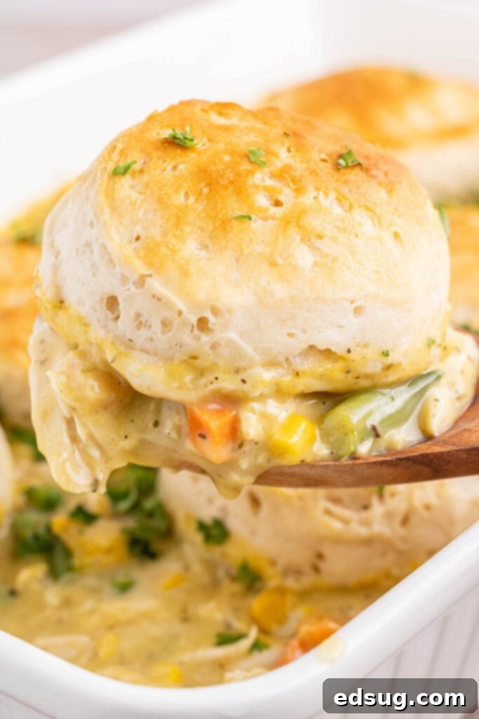 scooping chicken pot pie casserole out of baking dish