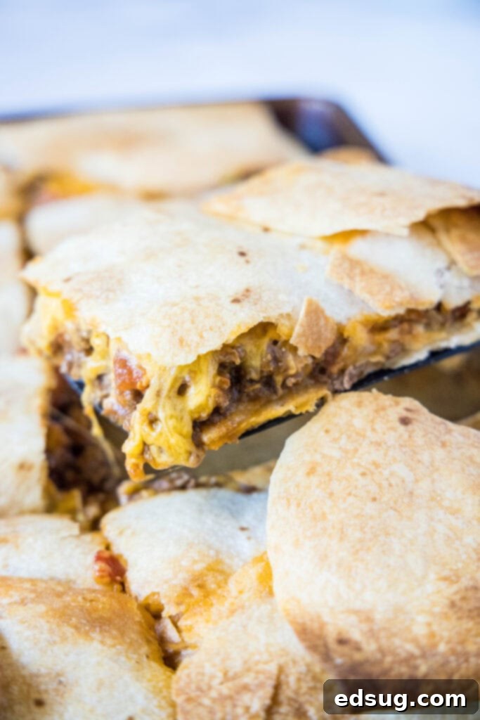 scooping a slice of sheet tacos off the tray